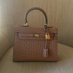 25cm brown leather ostrich top handle handbag tonal lock